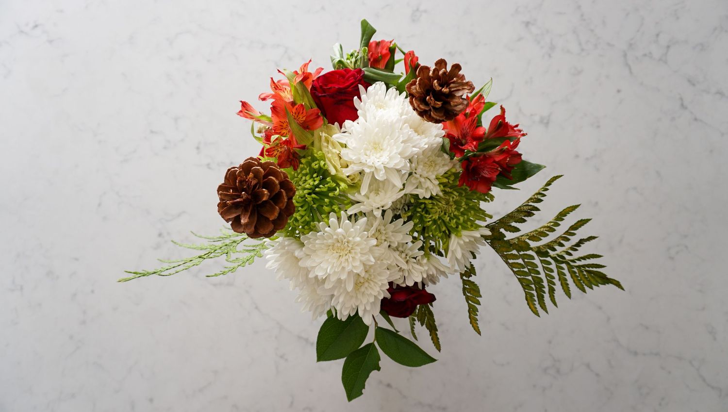 Elegant floral arrangements with red and white flowers against a light background.