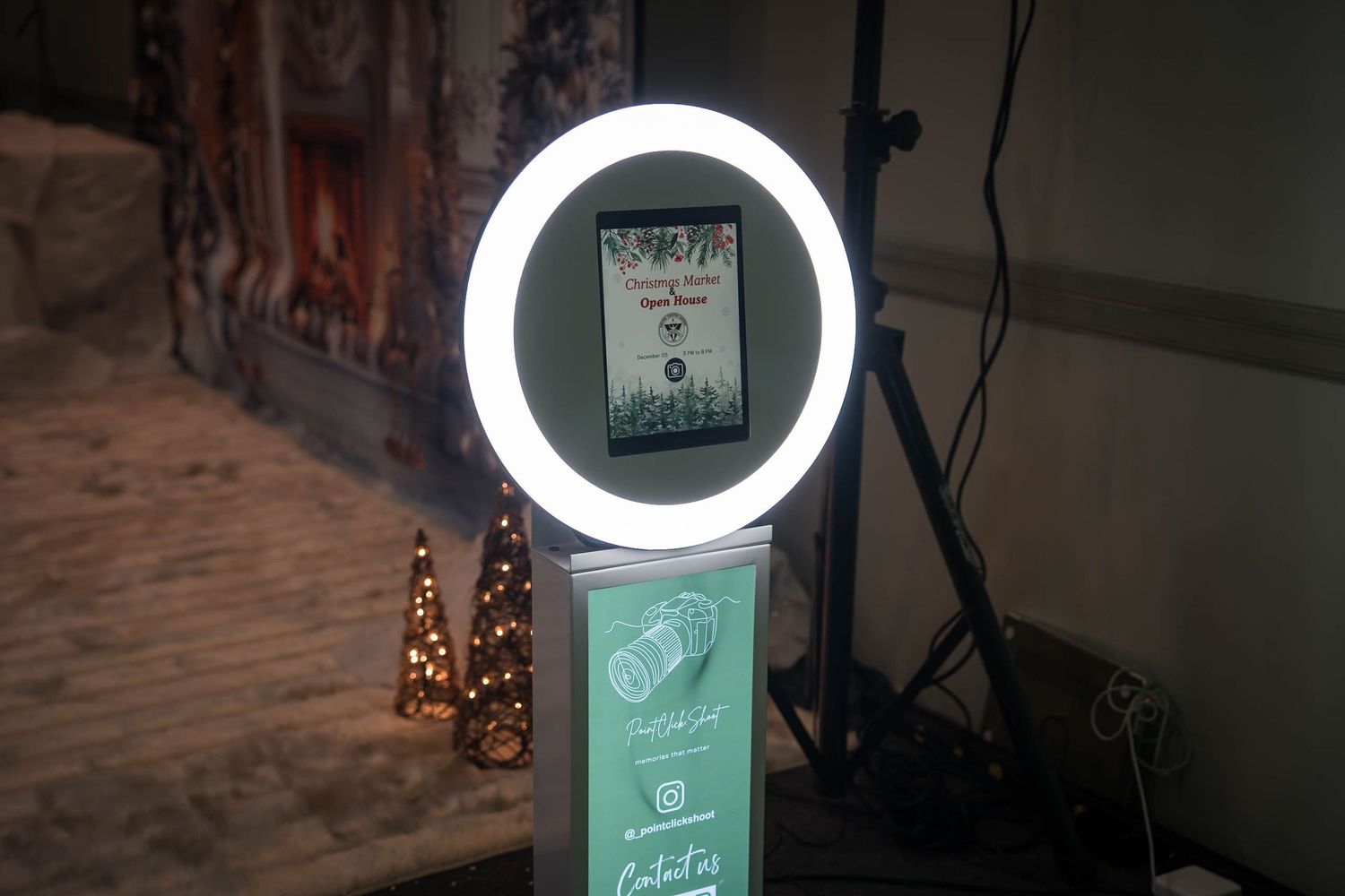 Ring light setup with promotional display stand in a photography studio.
