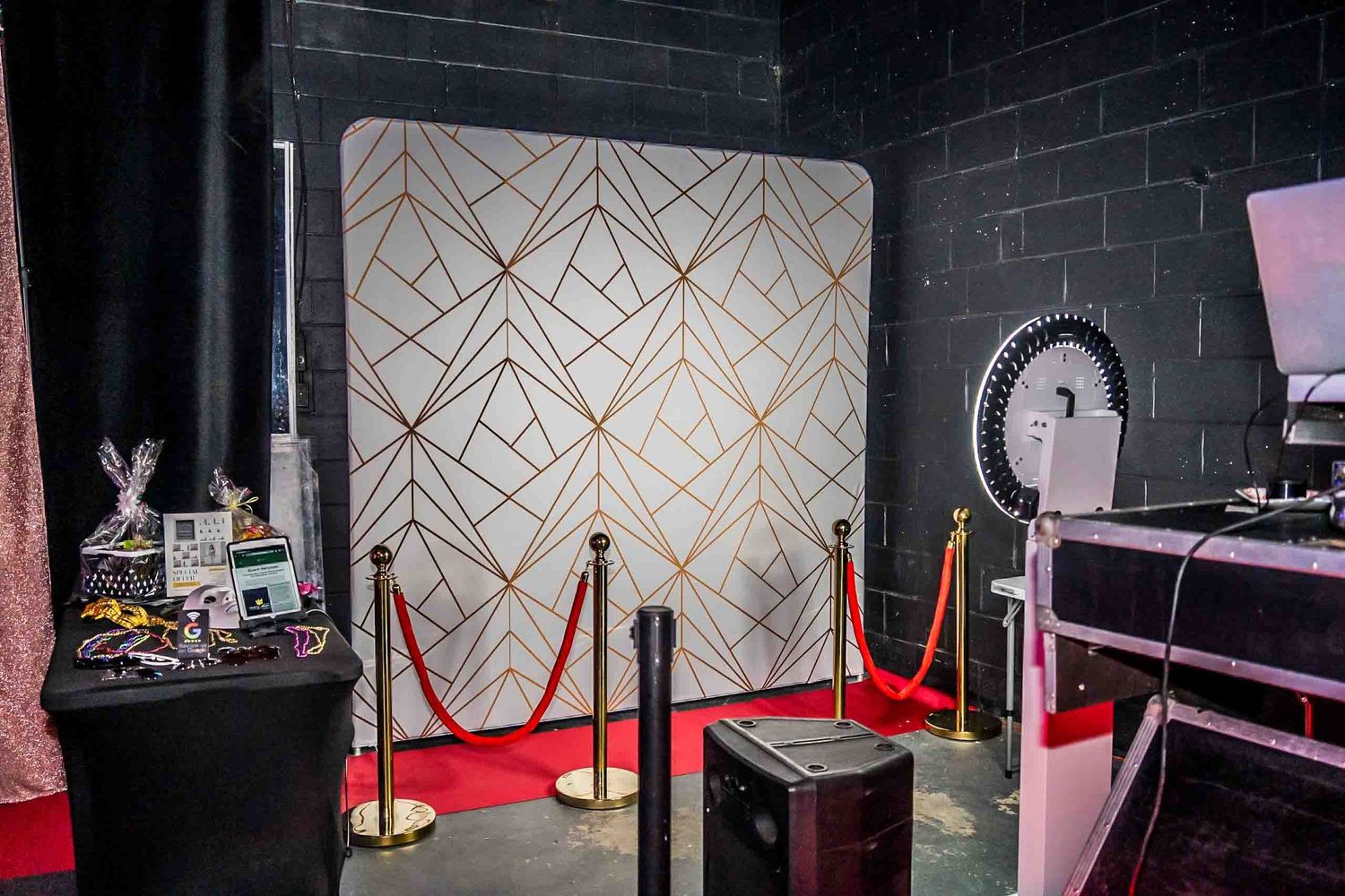 Event venue interior with geometric wall patterns and red rope barriers.