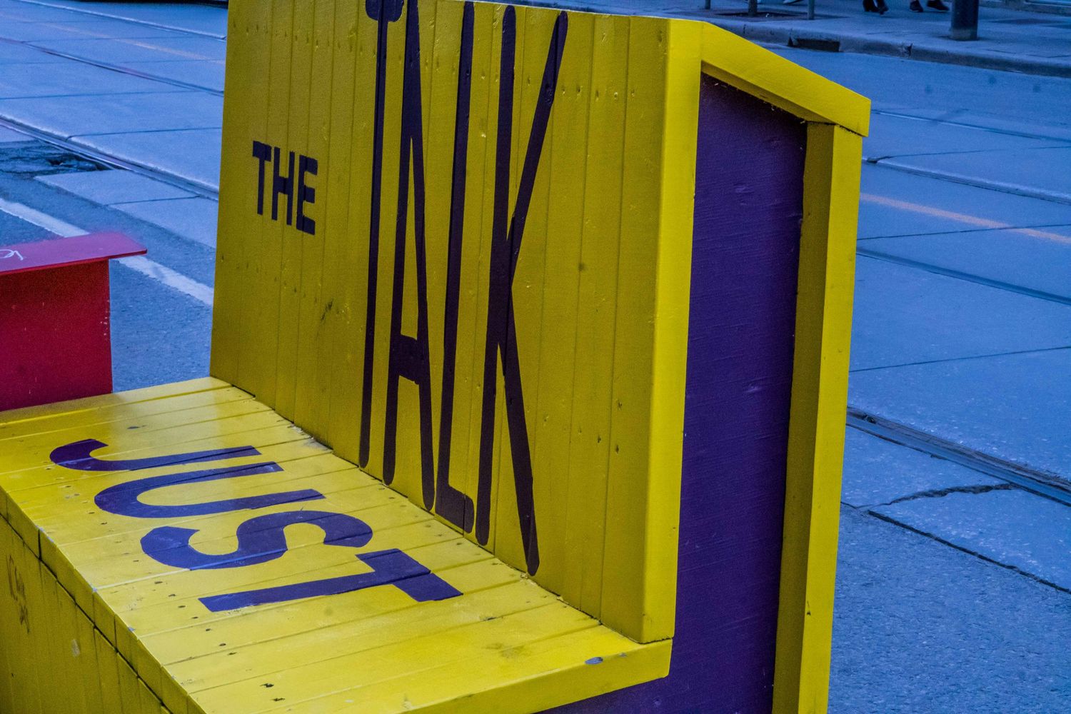 Yellow and purple geometric installation art or signage displayed outdoors.