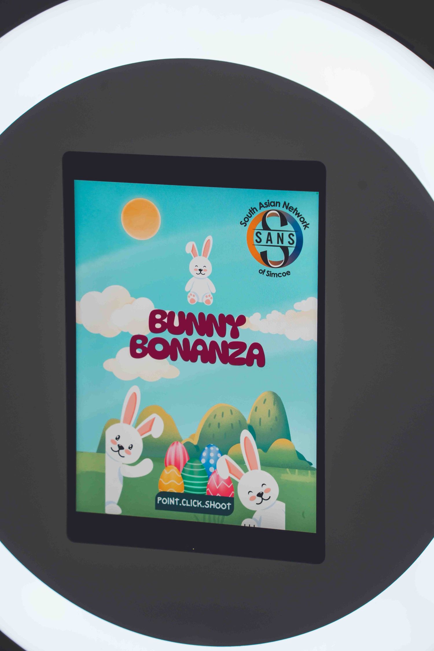 Animated game screen showing cartoon bunnies and colorful mountains against a blue sky background.