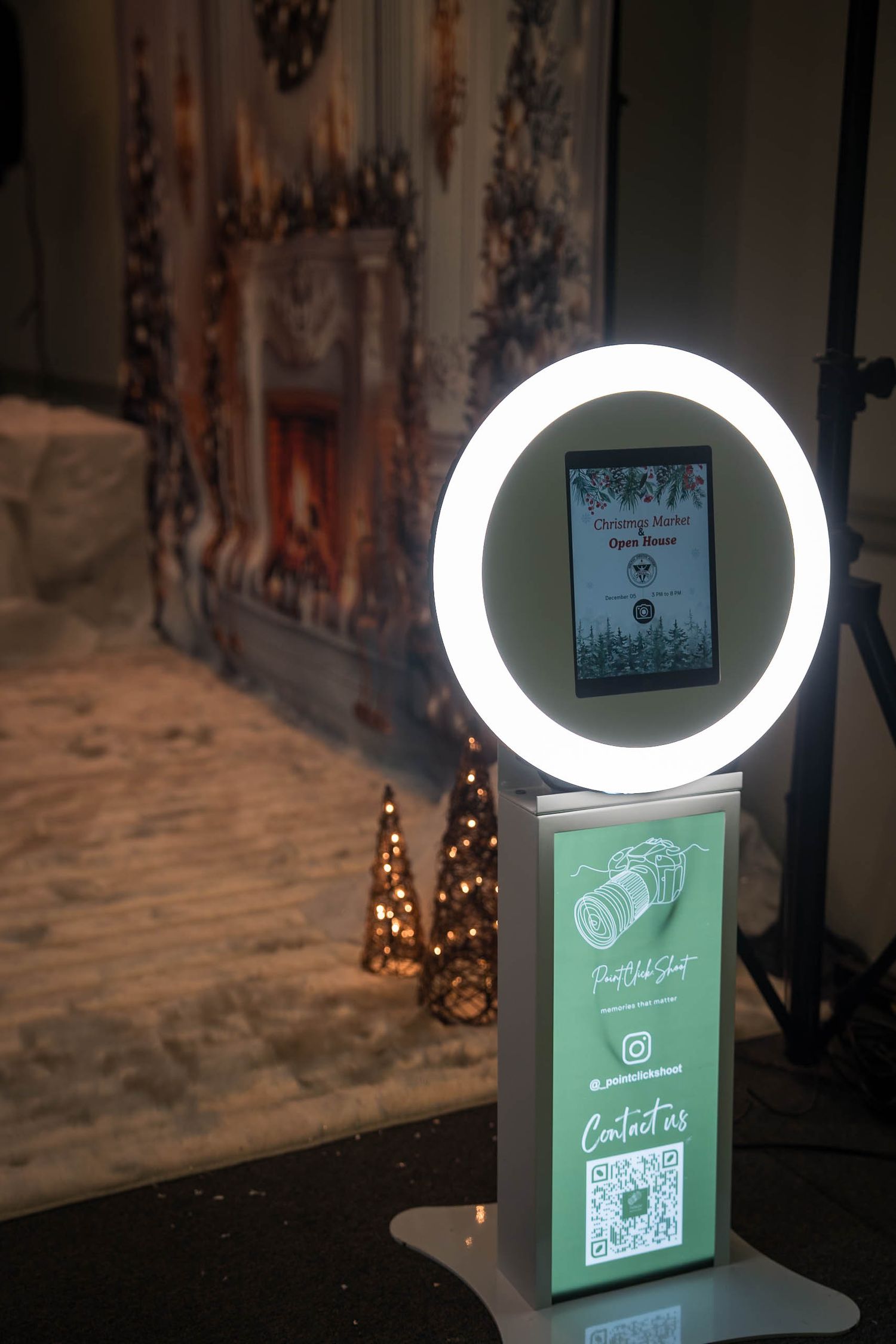 Ring light illuminating a green promotional display with QR code in studio setting.