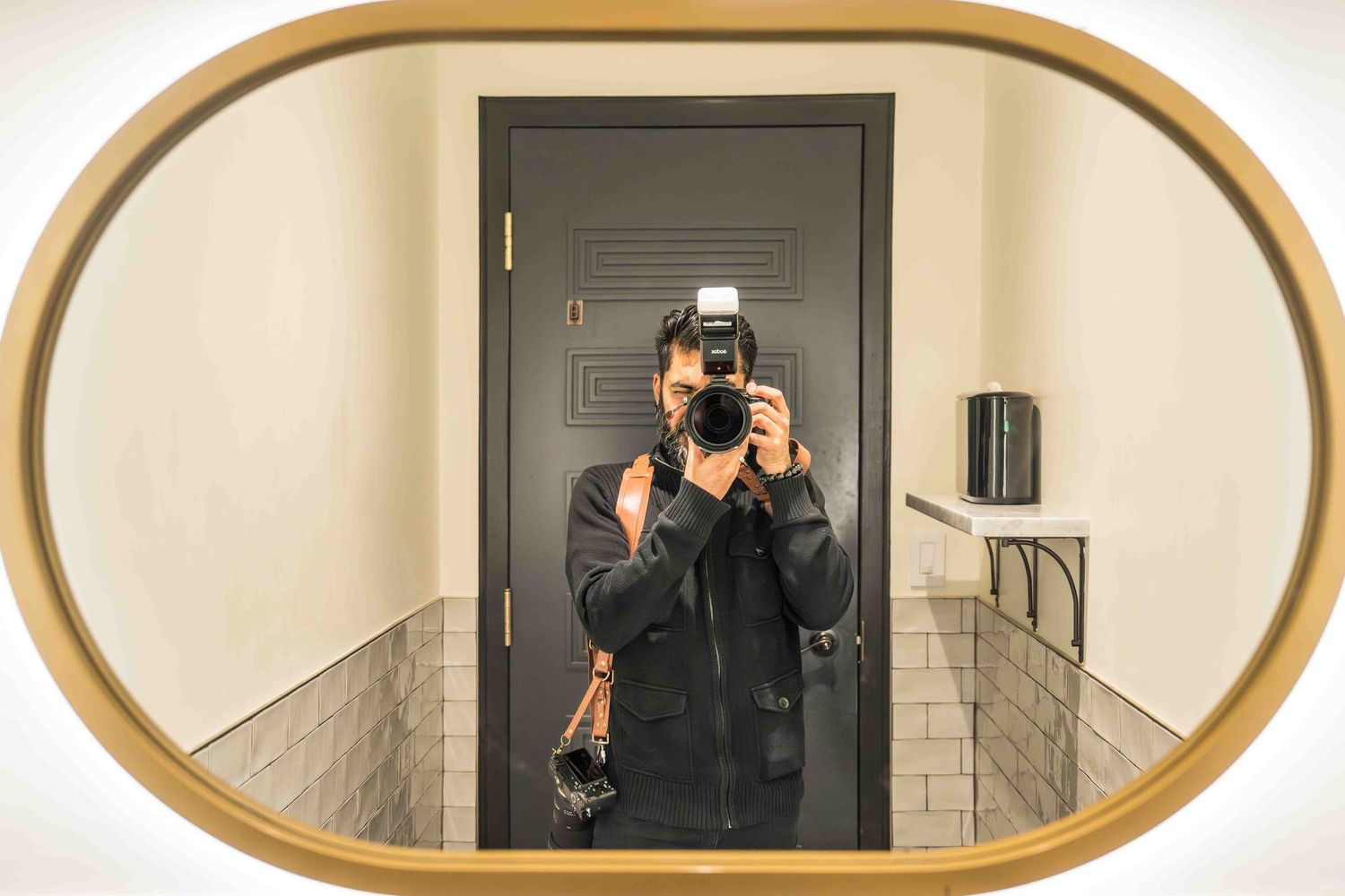 Multiple shots of someone photographing themselves in an oval-shaped decorative wall mirror.