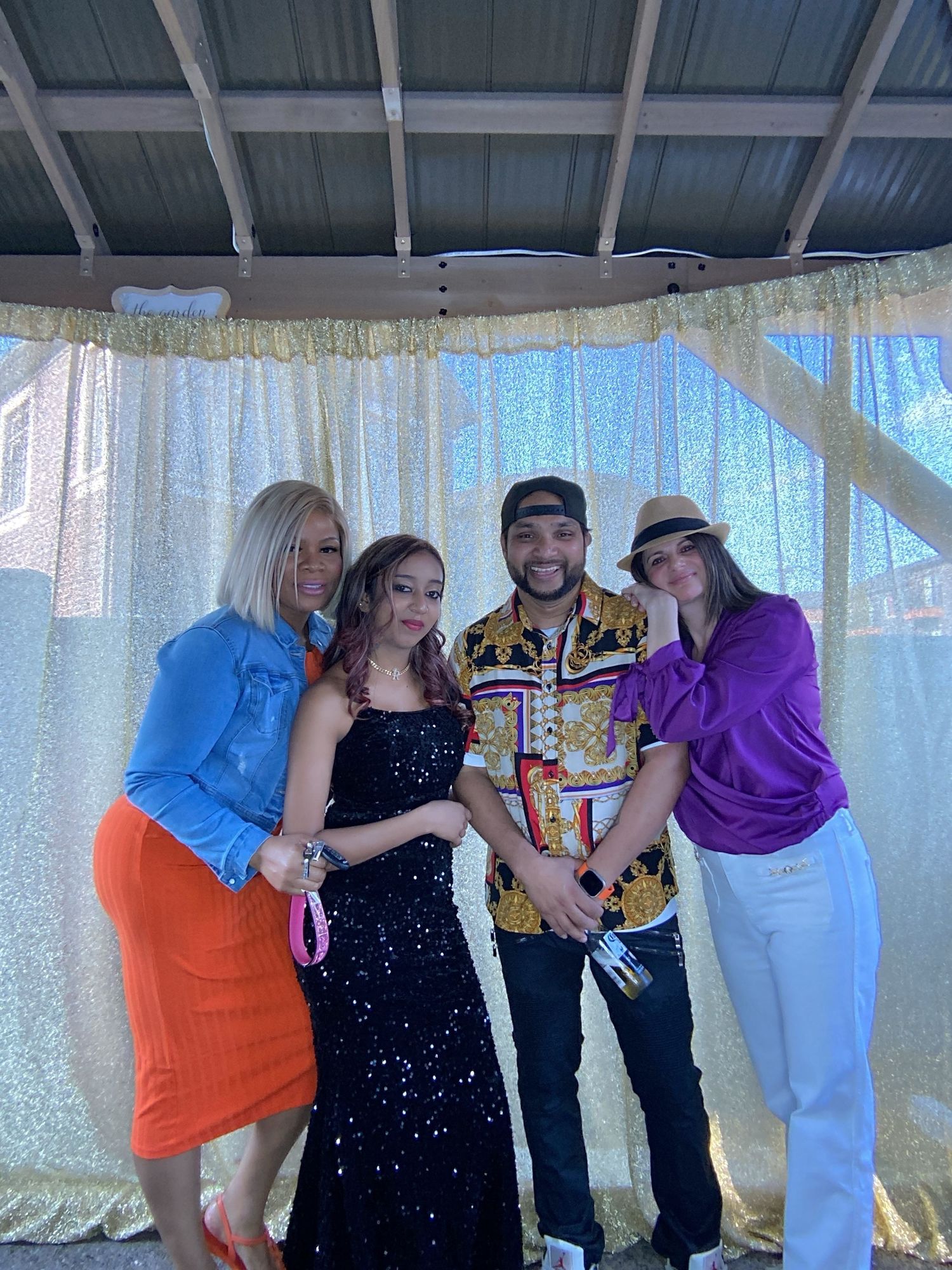 Group celebration photos with people posing together under a covered outdoor area.