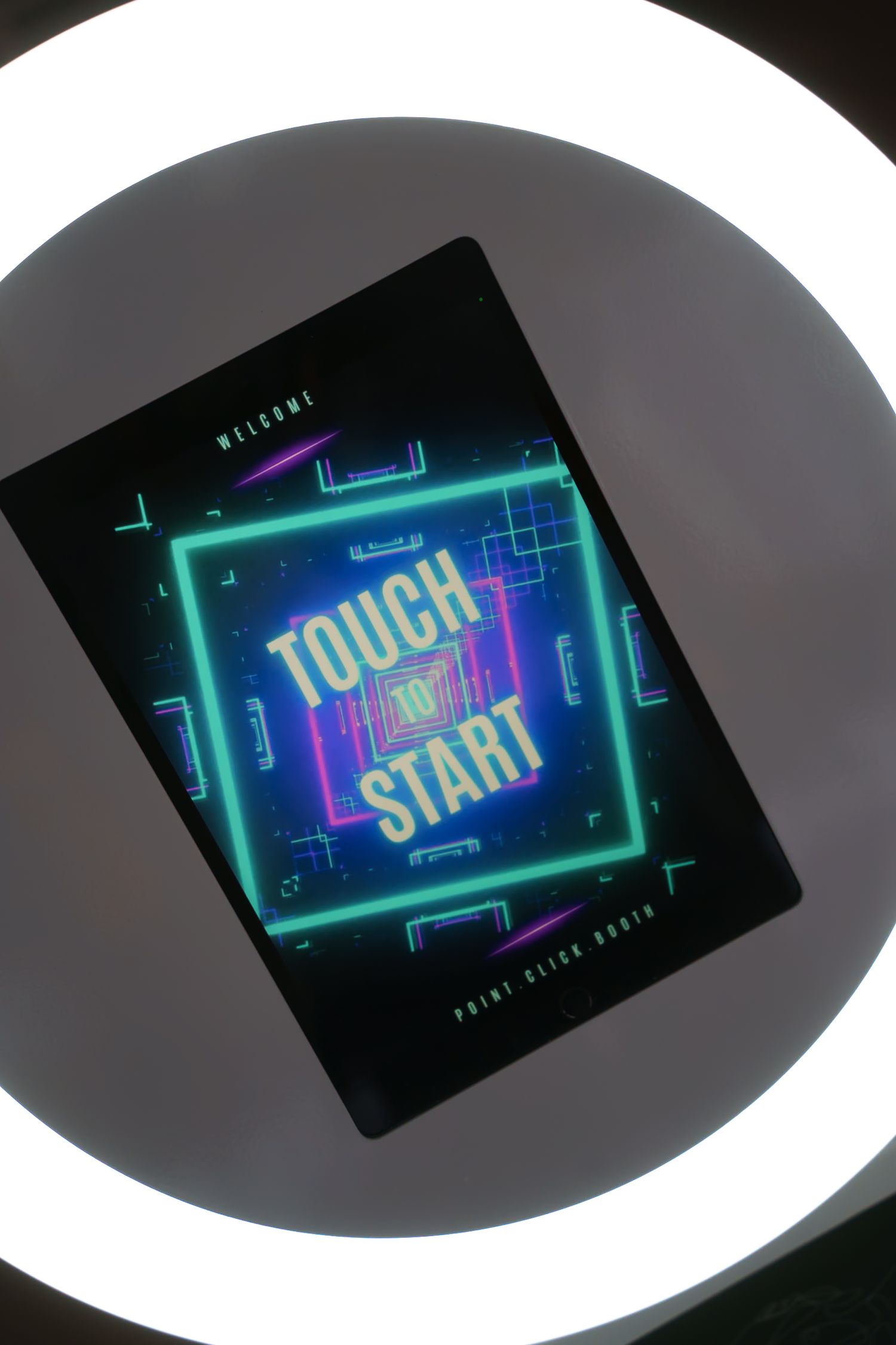 Touch to Start screen displayed within a circular ring light against dark background.