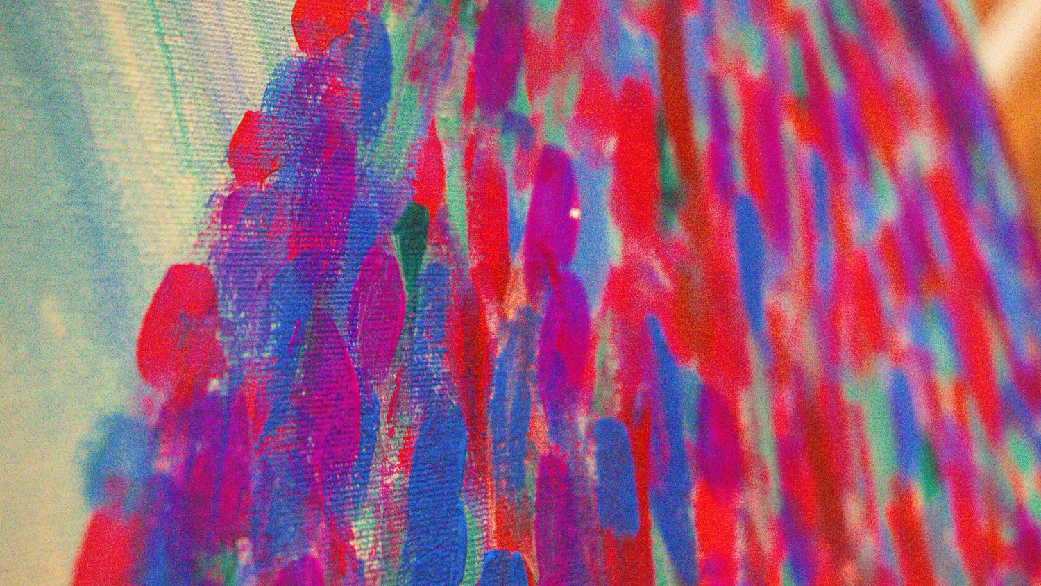 Abstract watercolor painting with vibrant red and blue vertical streaks on canvas.