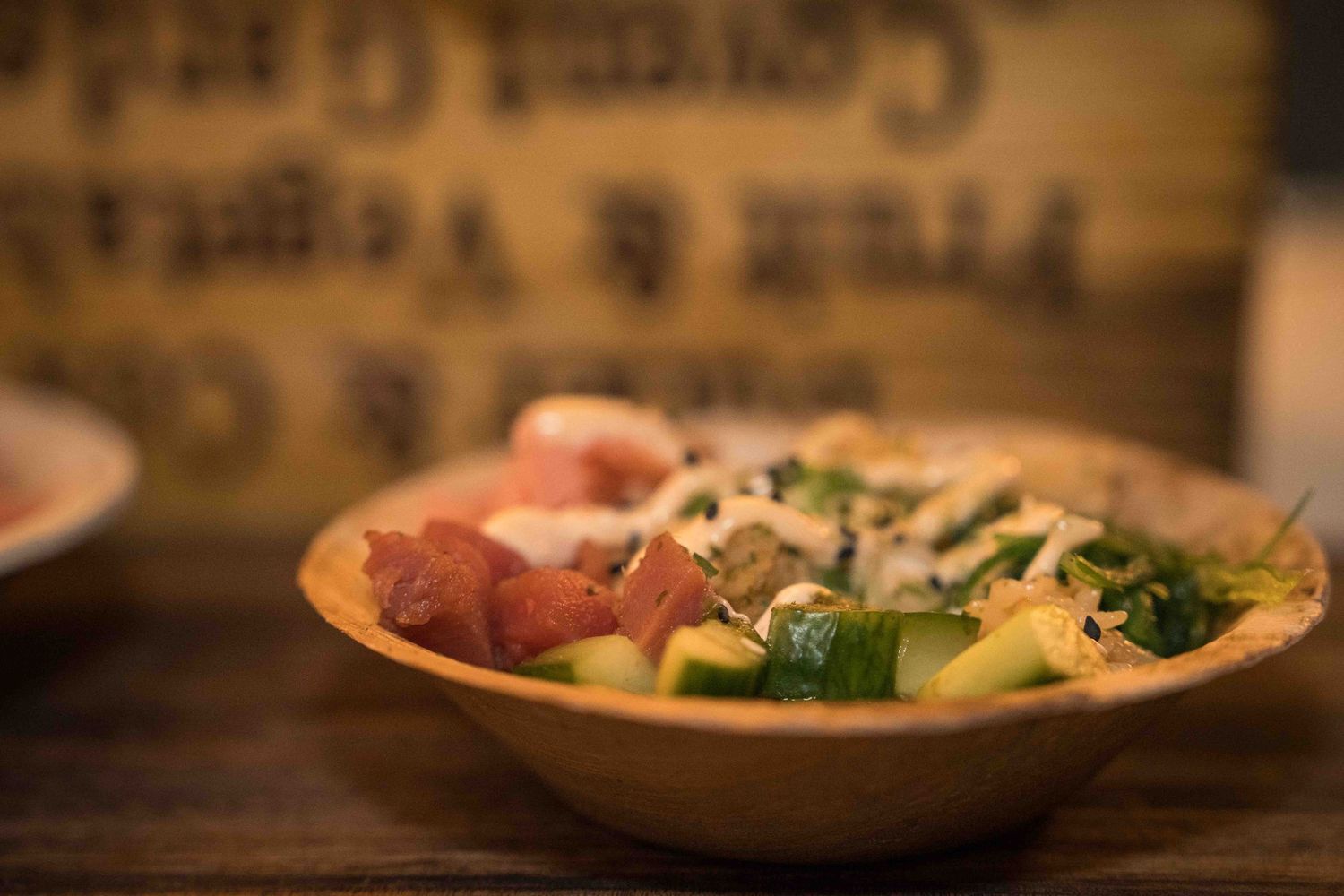 Fresh salad dishes and appetizers arranged on rustic wooden serving boards in warm lighting.