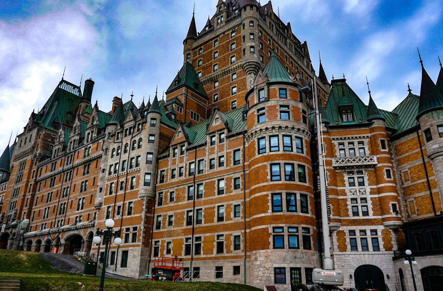 Panoramic view of Chateau Frontenac's grand architecture against blue sky.