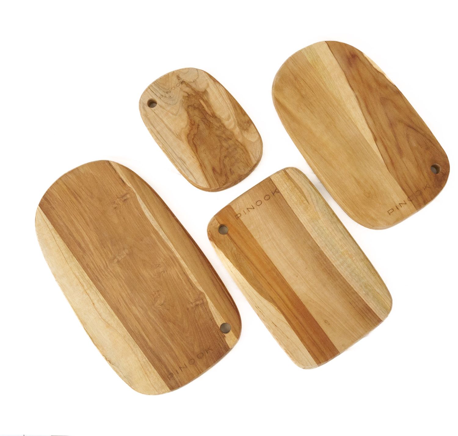 Set of four natural wood cutting boards in various sizes with rounded edges by PINOO.