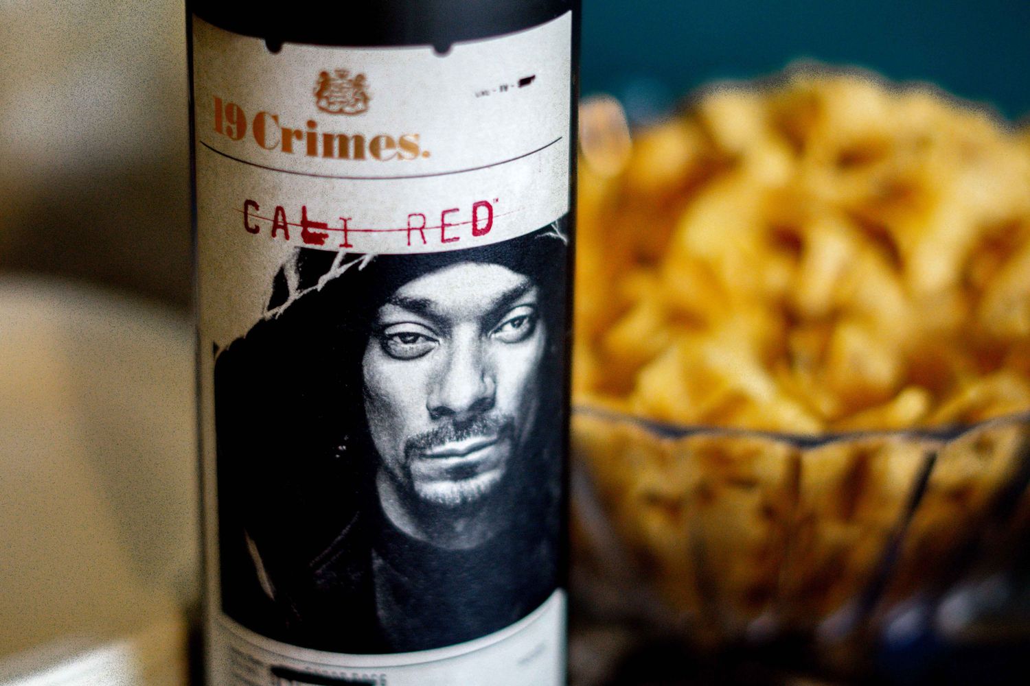 Close-up of wine bottle labels in dark moody lighting.
