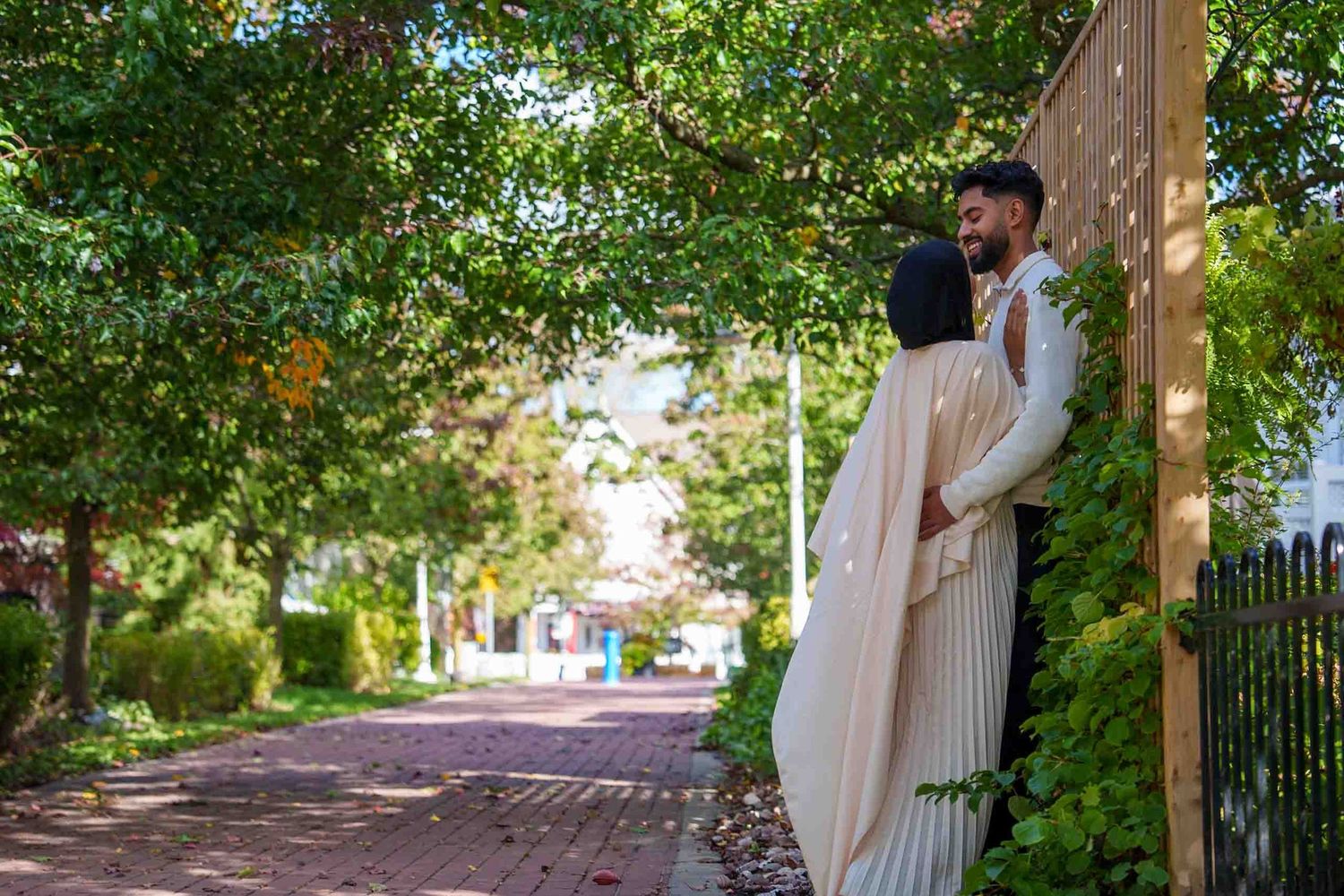 A romantic garden pathway scene with green trees and natural lighting.