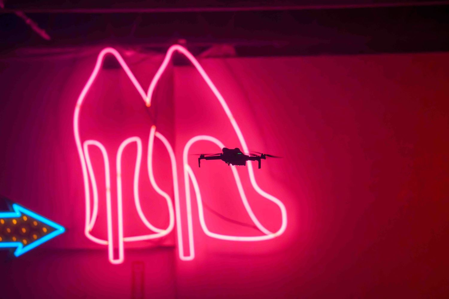 Neon pink signage glowing brightly in a dark environment.