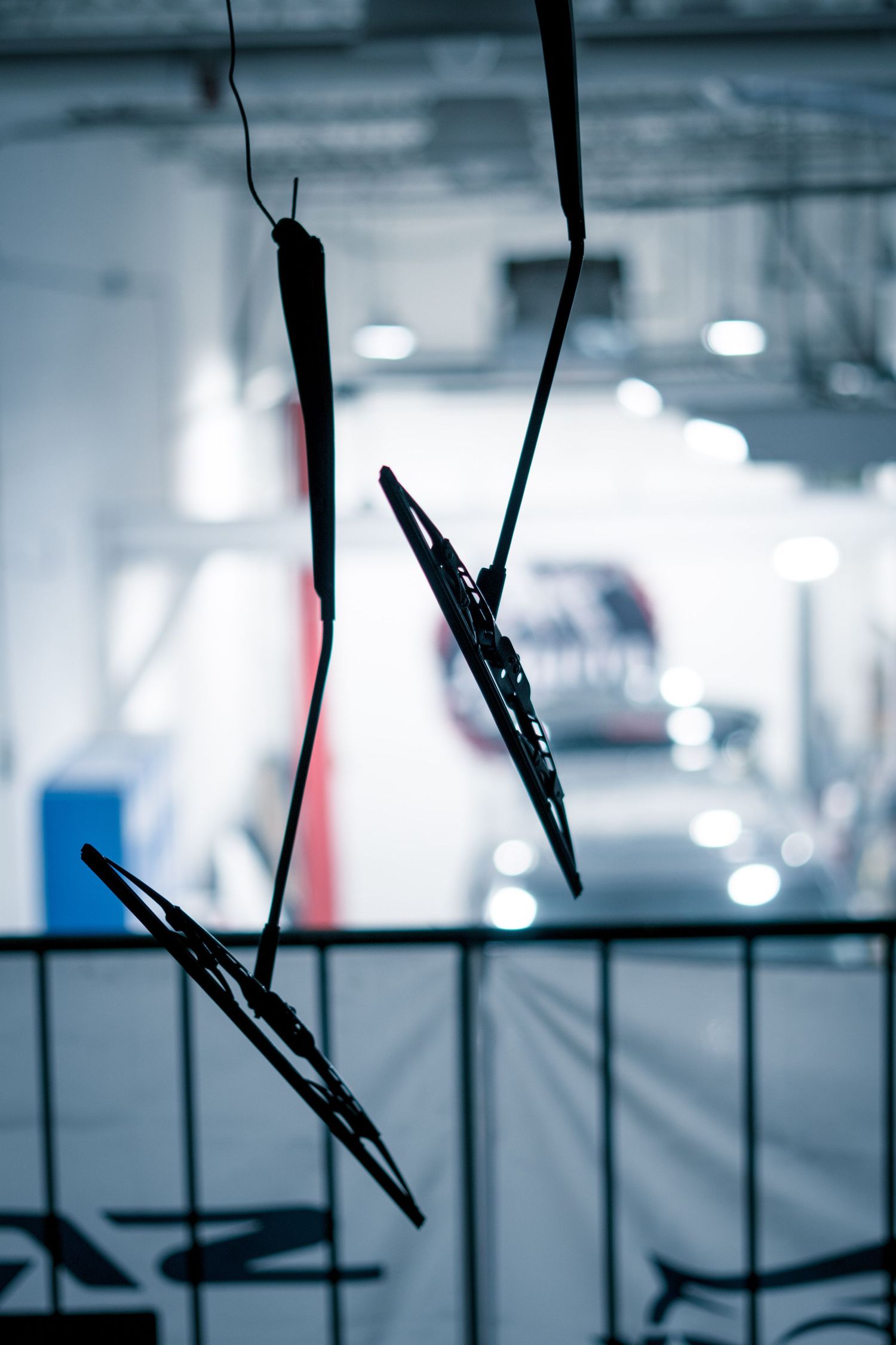 Abstract blurred images of car repair equipment in a garage setting.