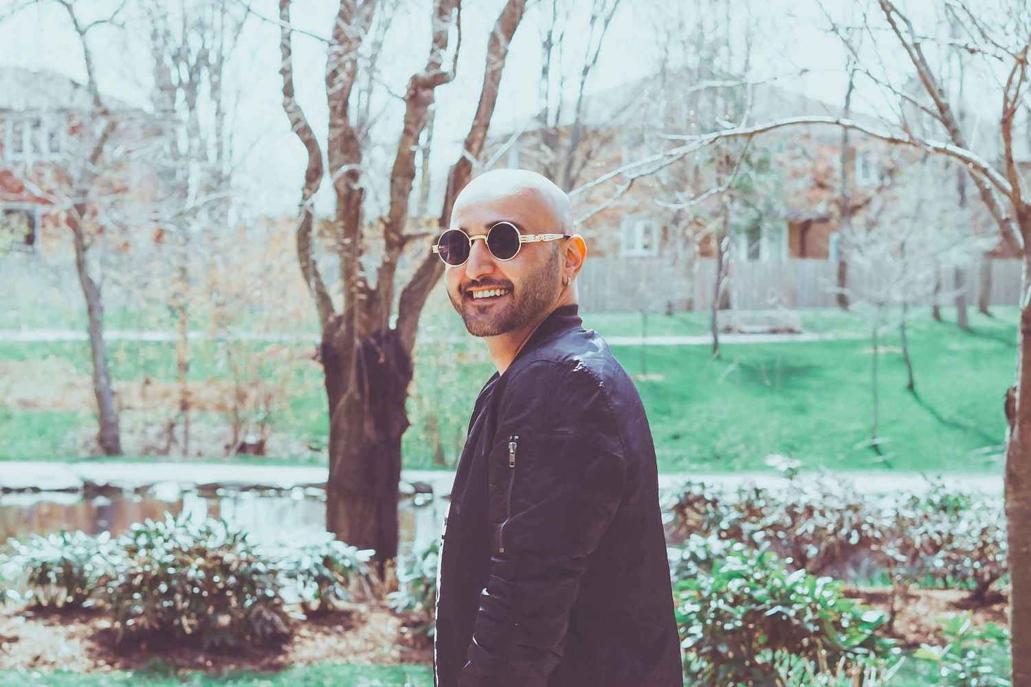 Candid outdoor portrait of person smiling in casual attire.