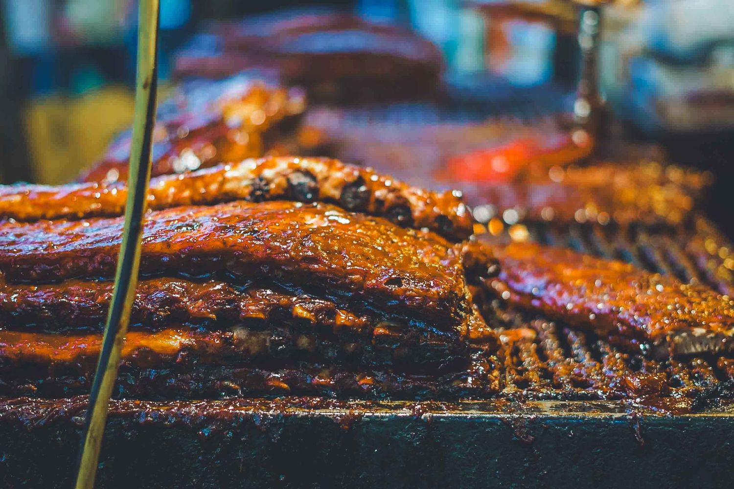 Grilled meat on barbecue with flames and smoke.