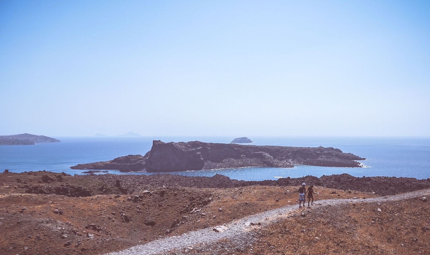 Rocky coastal landscape with ocean views under clear blue skies.