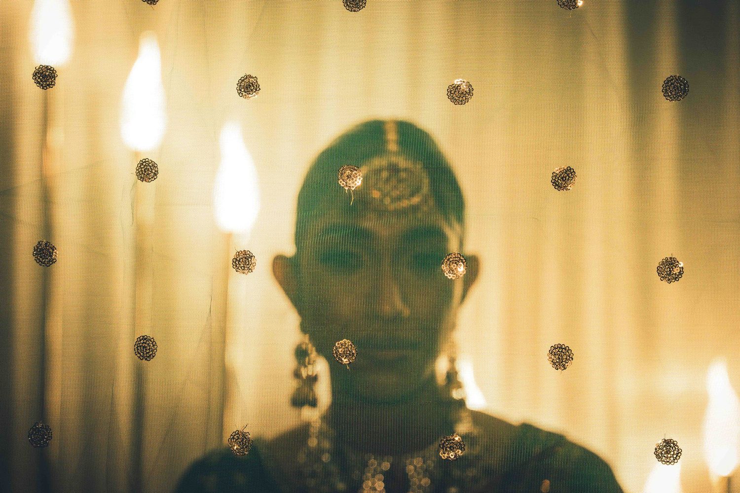 Artistic portrait silhouette against polka dot curtain with ethereal lighting and reflective elements.