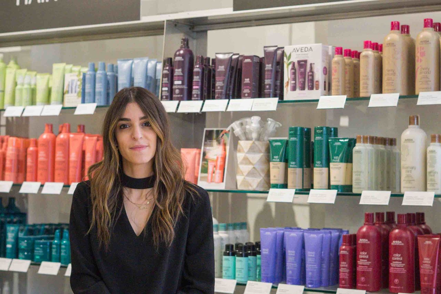 View of hair care product display shelves with colorful bottles and professional styling products.