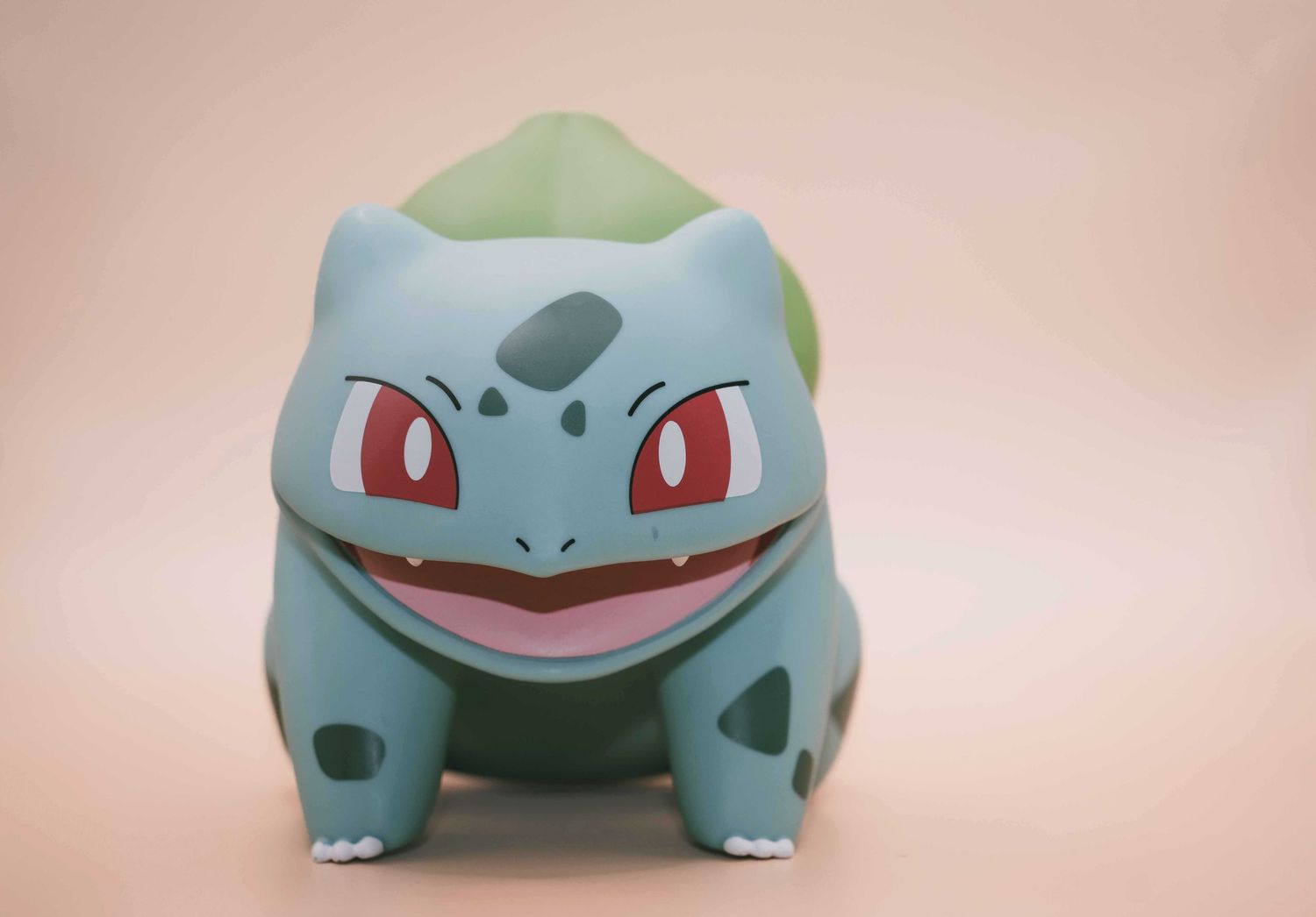Series of close-up shots showing a Bulbasaur Pokemon figure from various angles.