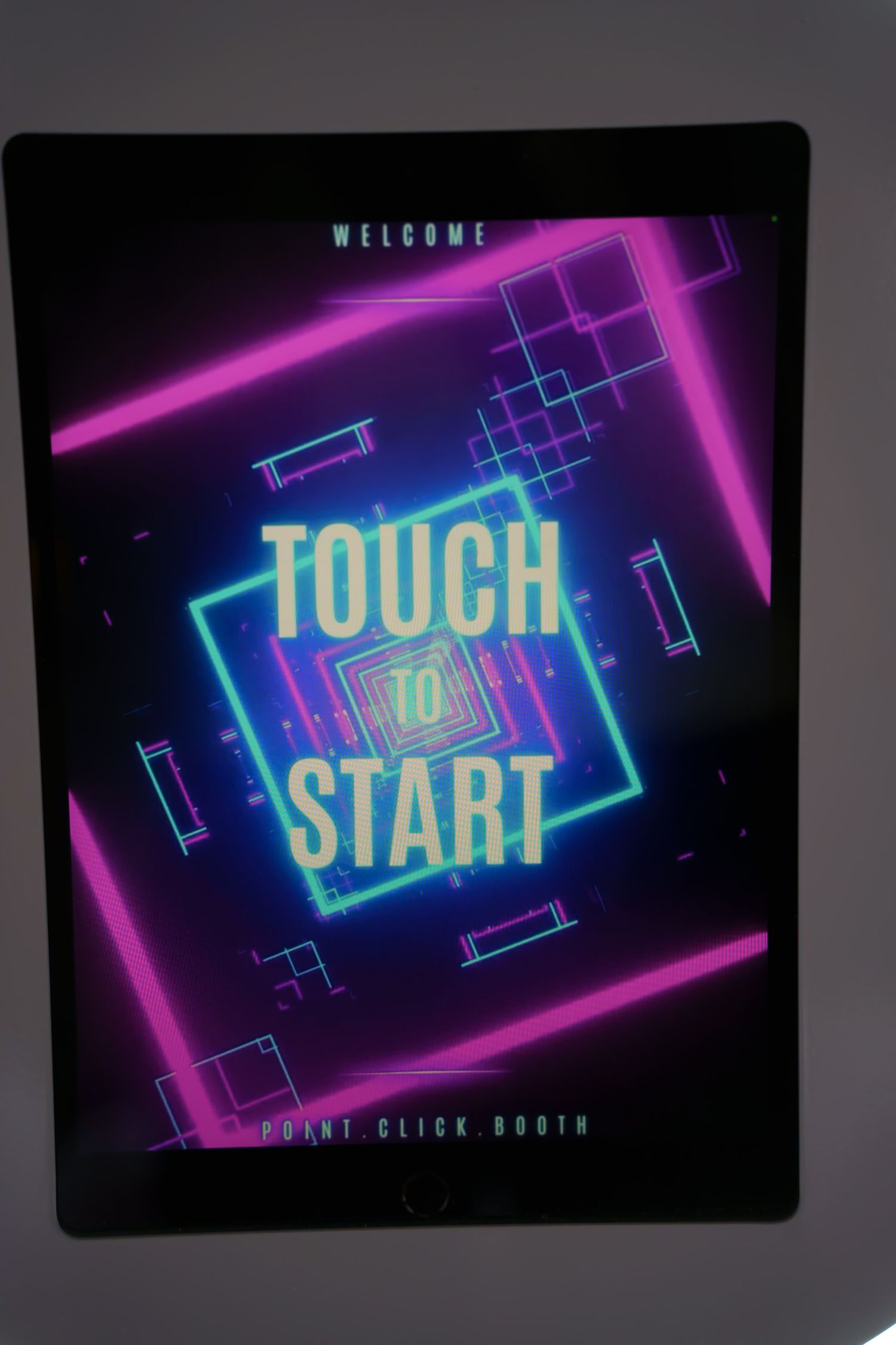 Retro neon 'Touch Start' welcome screen with geometric patterns in purple and blue glowing lights.