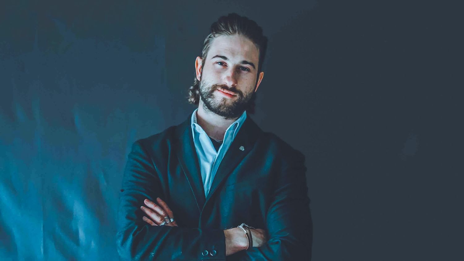 Row of professional portraits with dark blue background and dramatic side lighting.