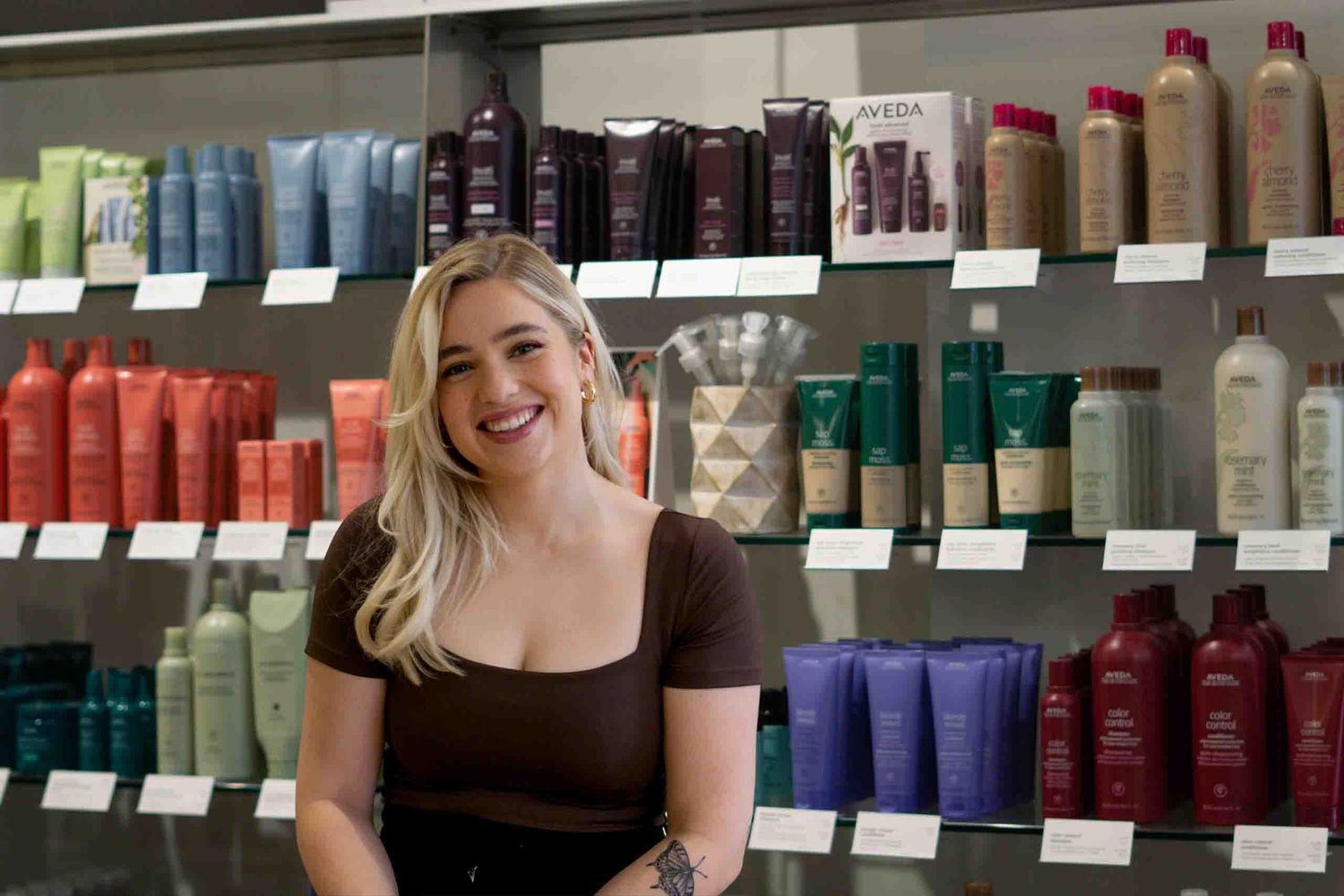 A cheerful salon scene with colorful product displays and shelving in the background.