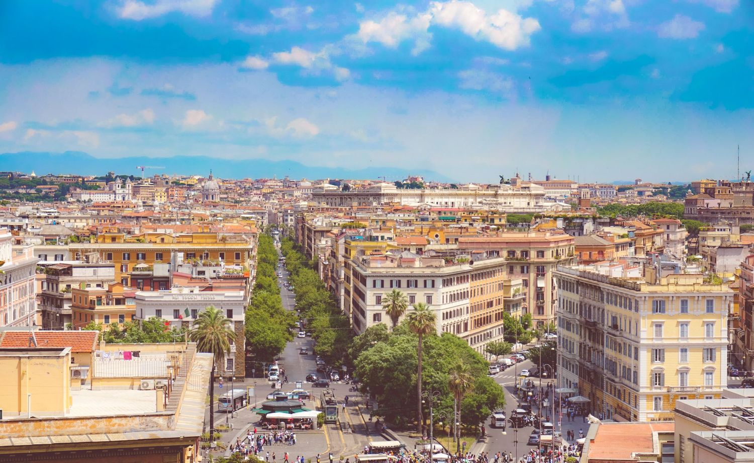 Aerial view of Rome's historic cityscape with buildings and streets stretching to the horizon.
