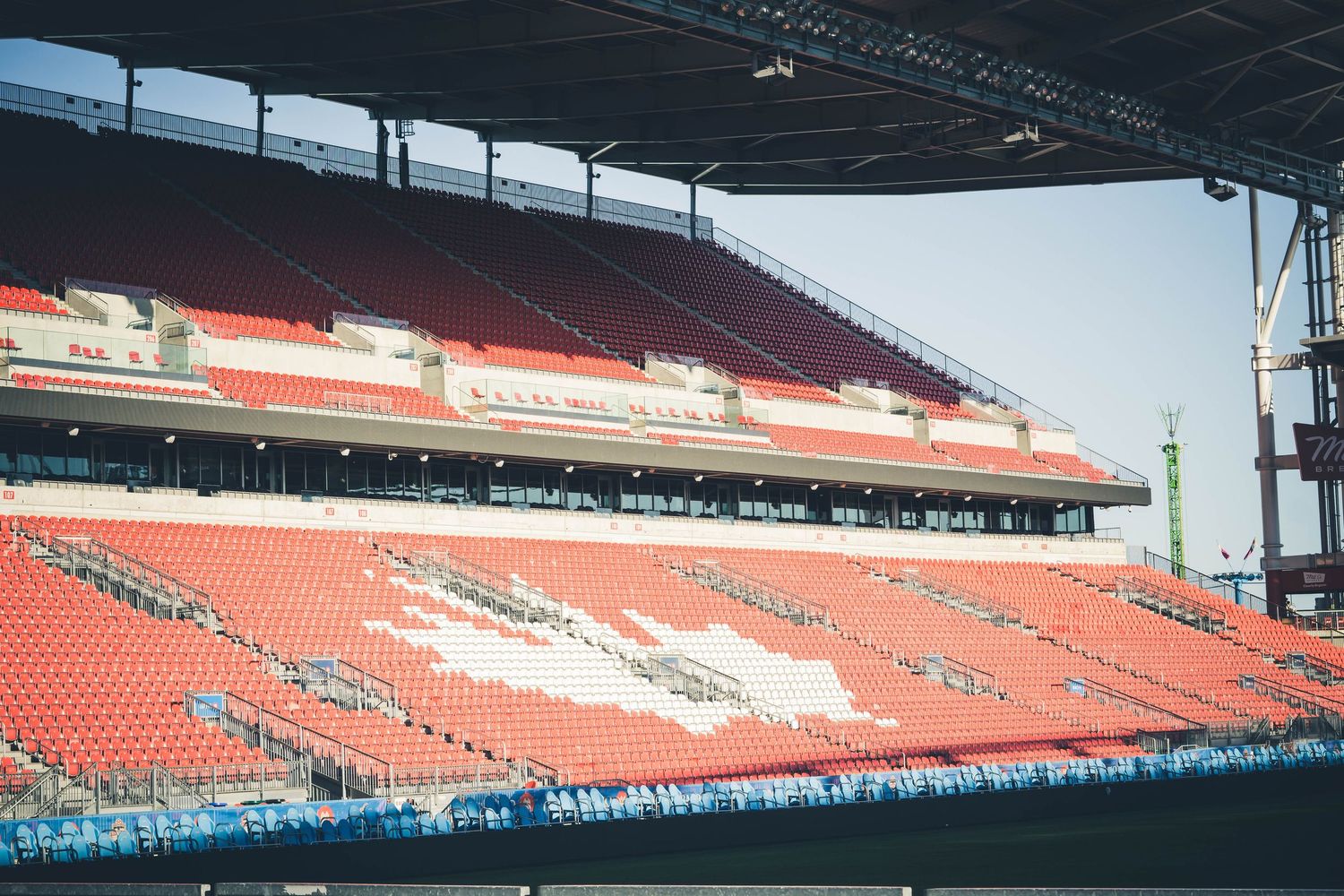 Empty red stadium seating section under covered grandstand at BMO Field.