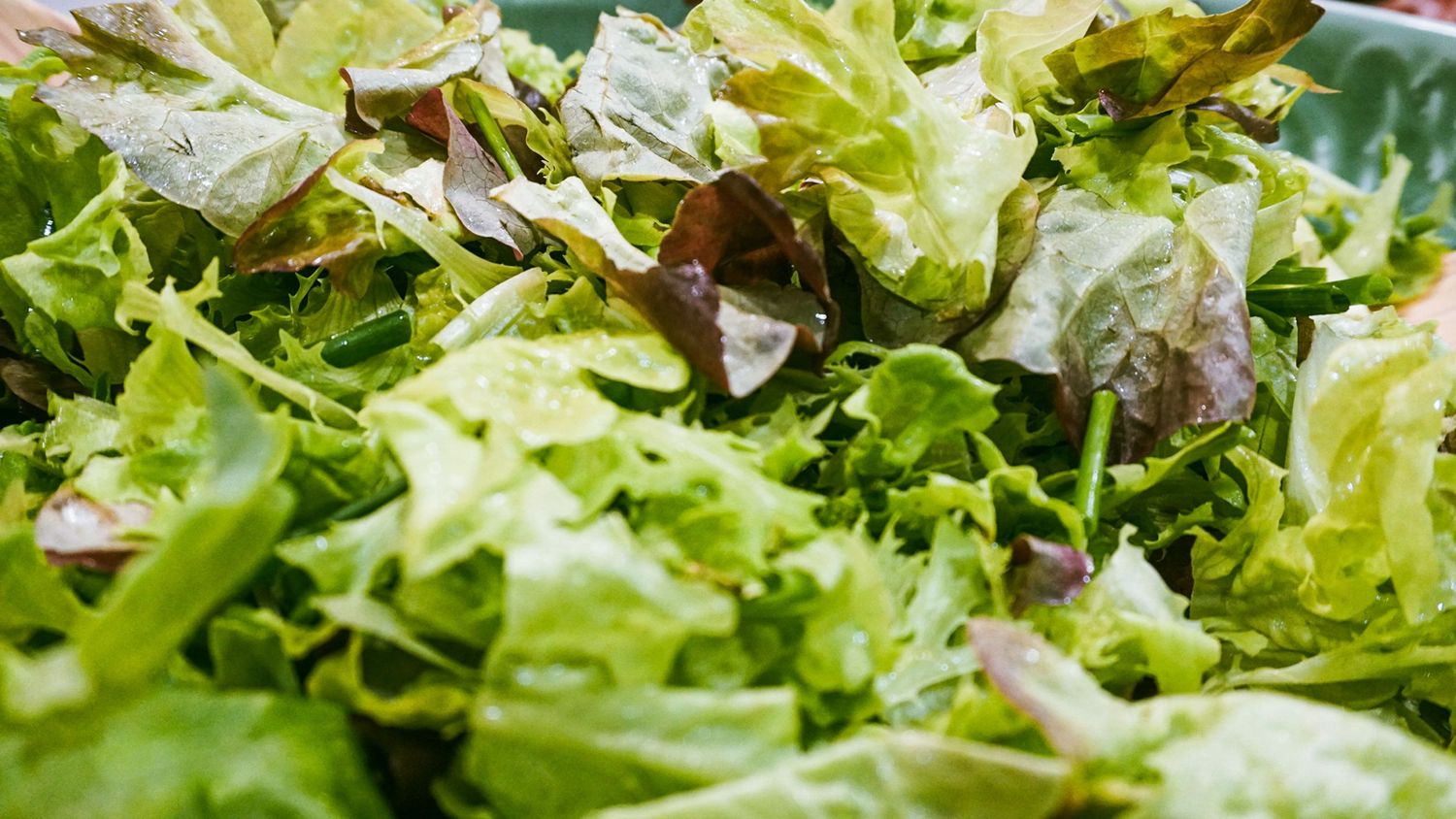 Fresh green lettuce leaves creating a vibrant salad background.