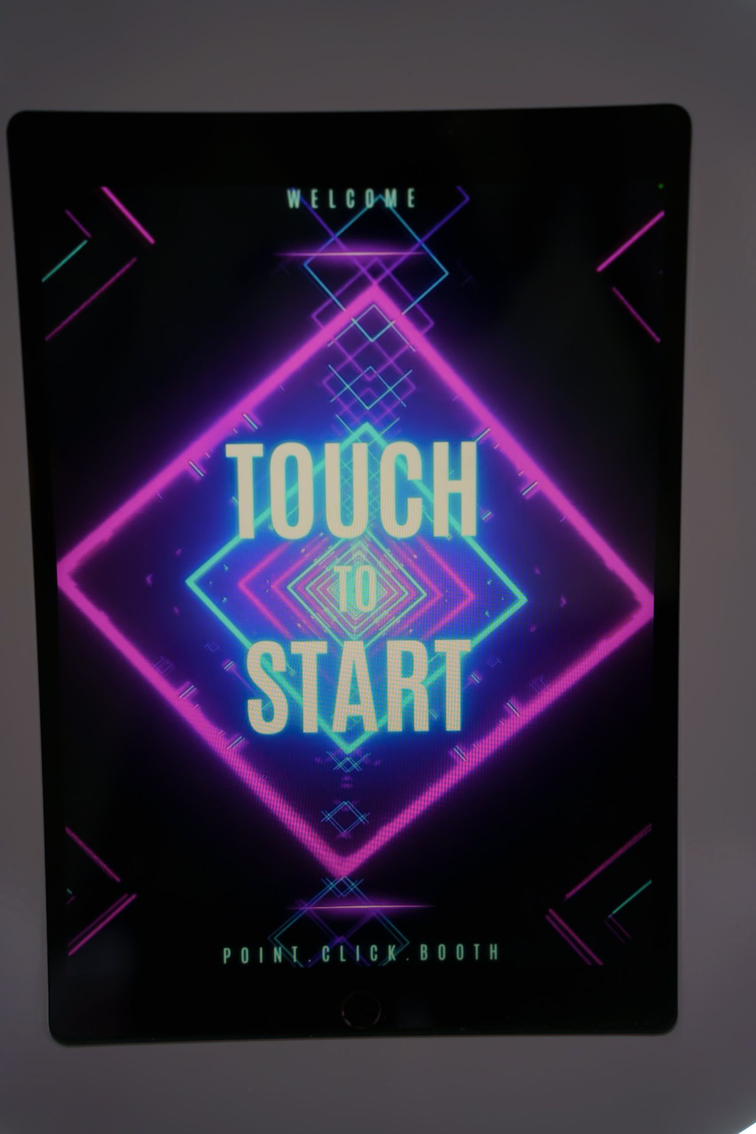 Neon touch-to-start interface with geometric patterns in pink and blue lighting.