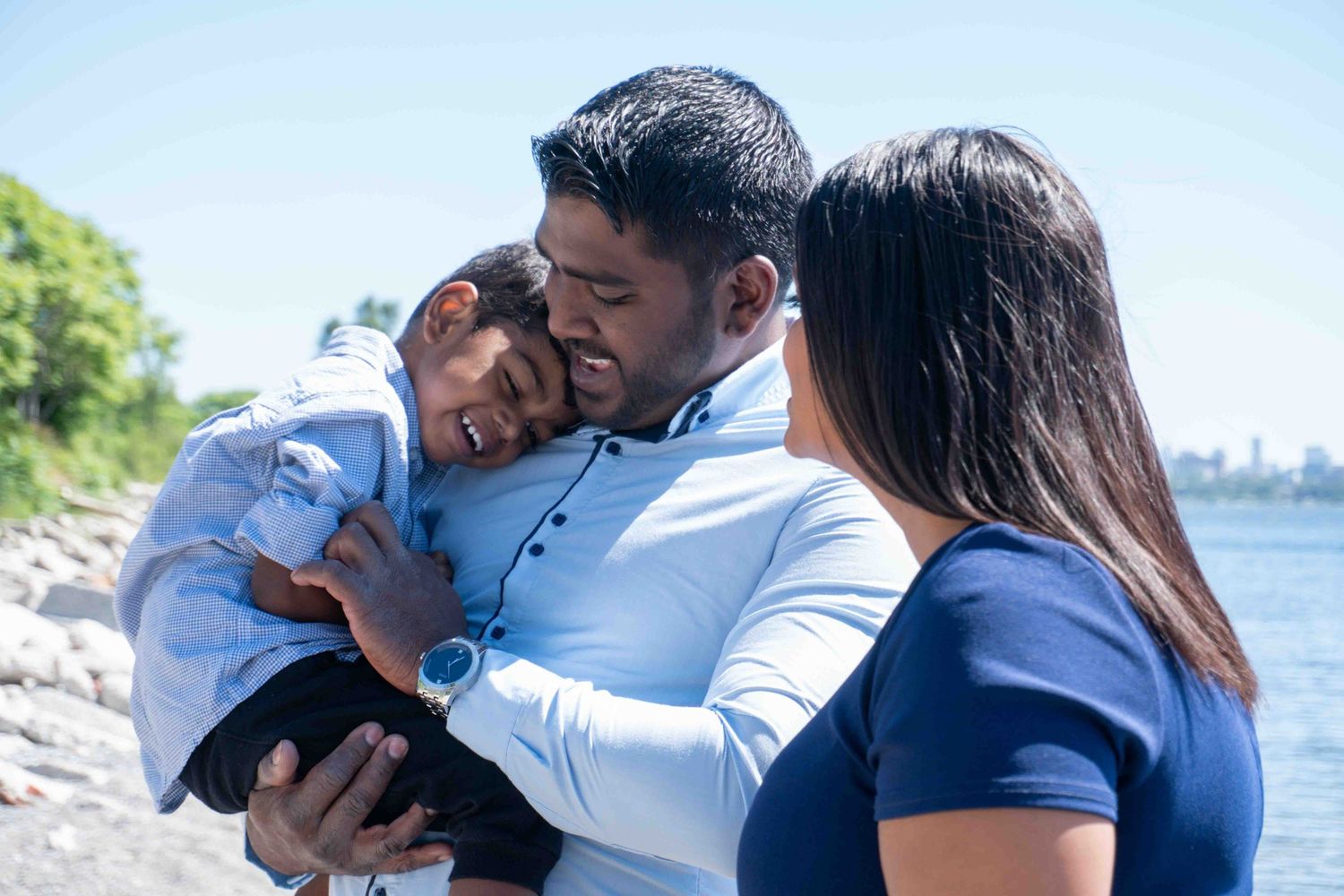 Candid outdoor family moments captured by the waterfront.