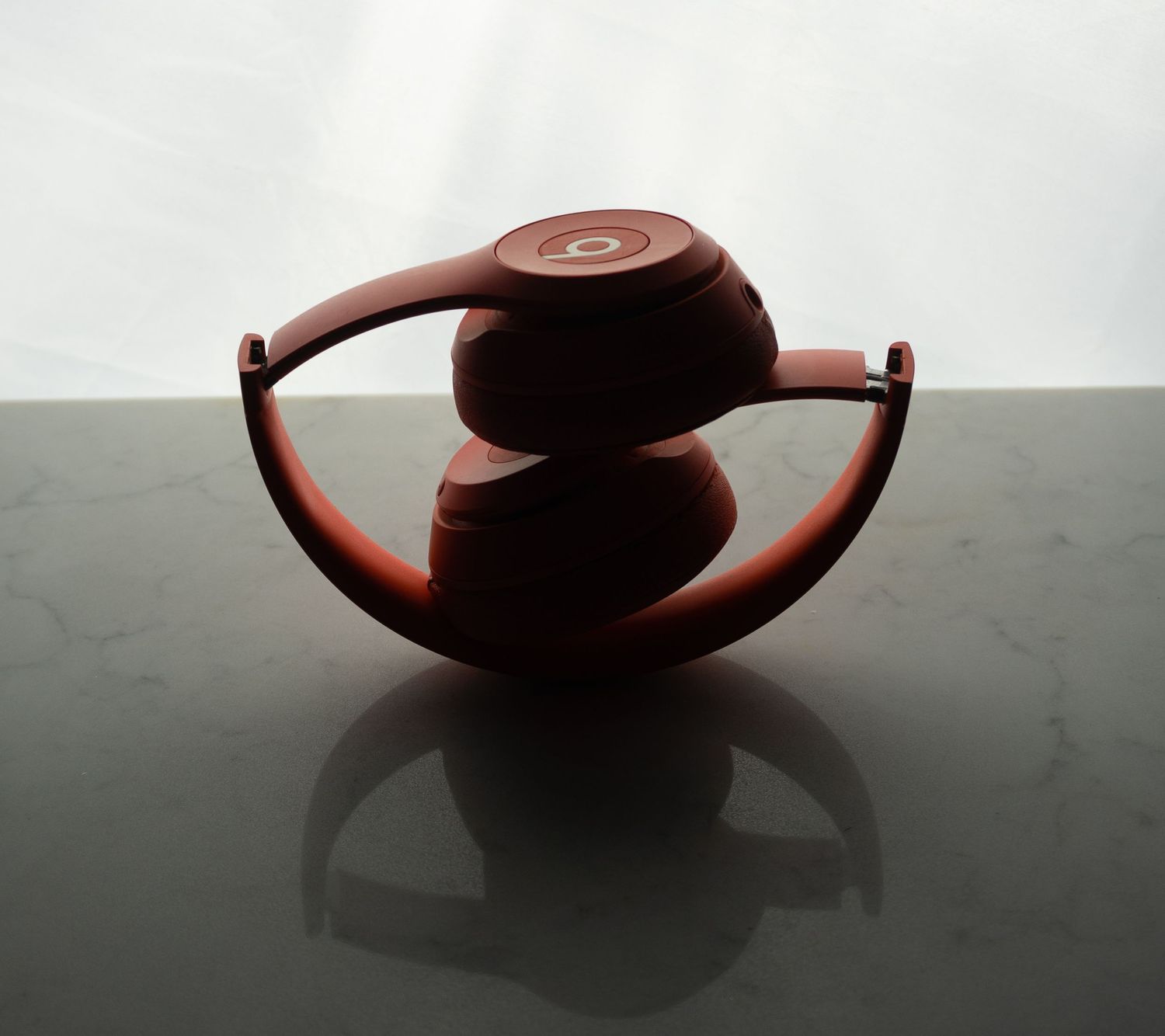 A series of artistic photos showing a dark wooden bowl casting shadows in dramatic lighting.