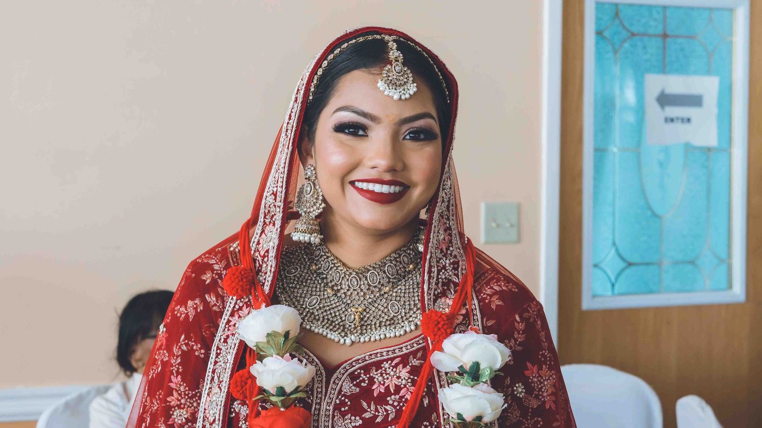 Couple in traditional Indian wedding attire posing together during a ceremony.