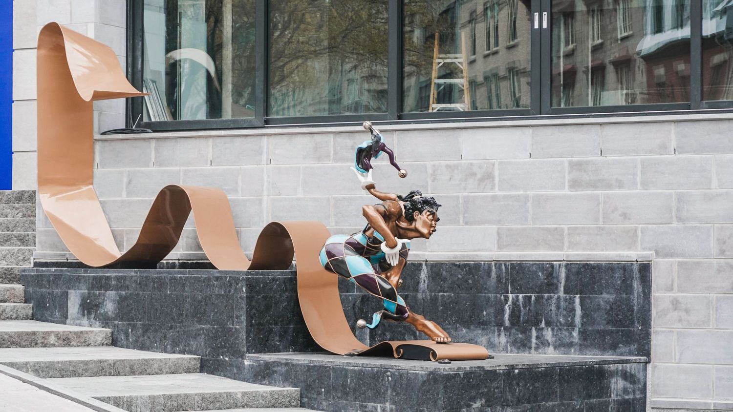Urban skateboarding area with concrete ramps and metal railings.