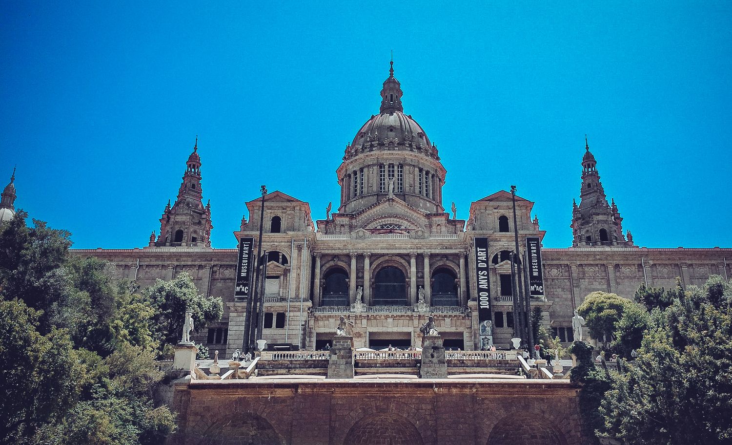 Majestic Spanish Renaissance style palace with domed central tower and ornate architectural details.