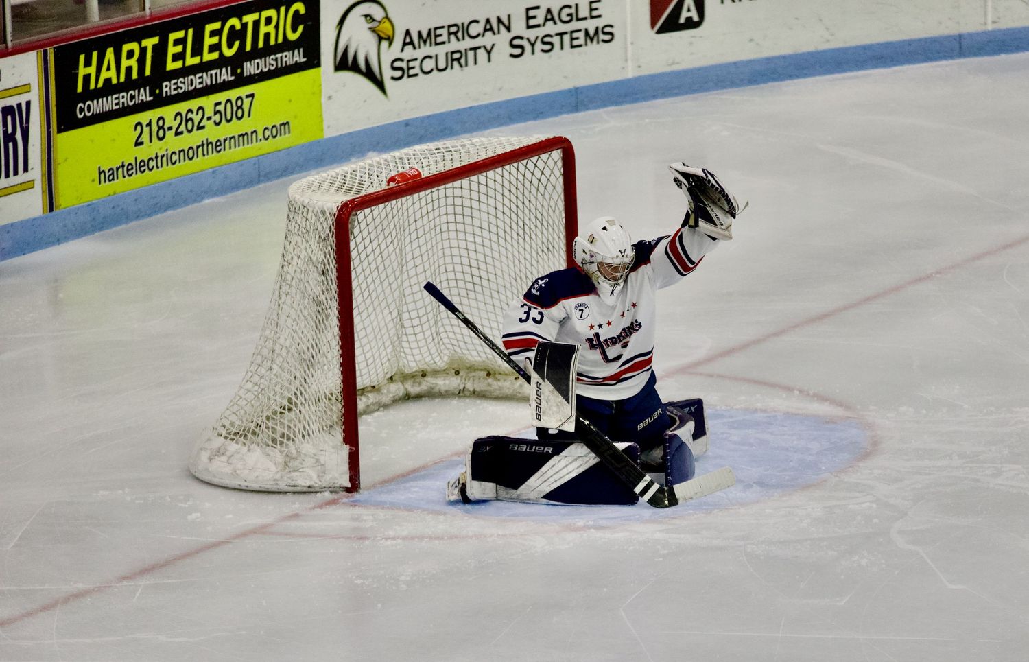 Northern MN hockey action shot capturing intensity, movement, and athletic performance