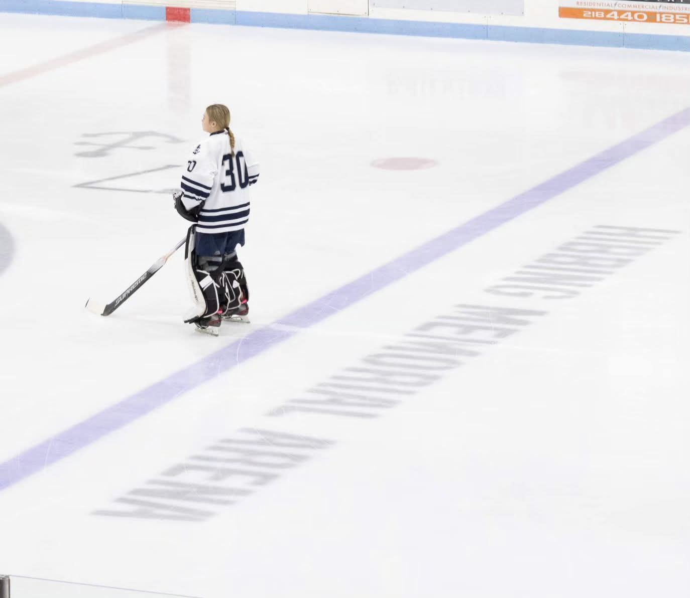 Professional sports photographer in Northern Minnesota photographing high school and youth hockey players
