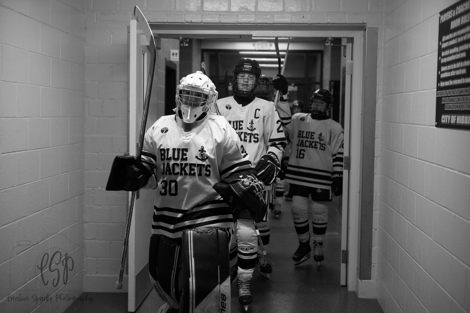 High school hockey photography in Northern Minnesota showcasing game action and teamwork