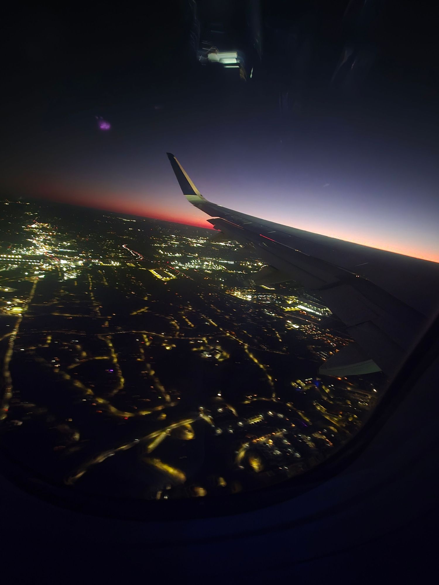 Night flight aerial photography capturing lights and streets from above