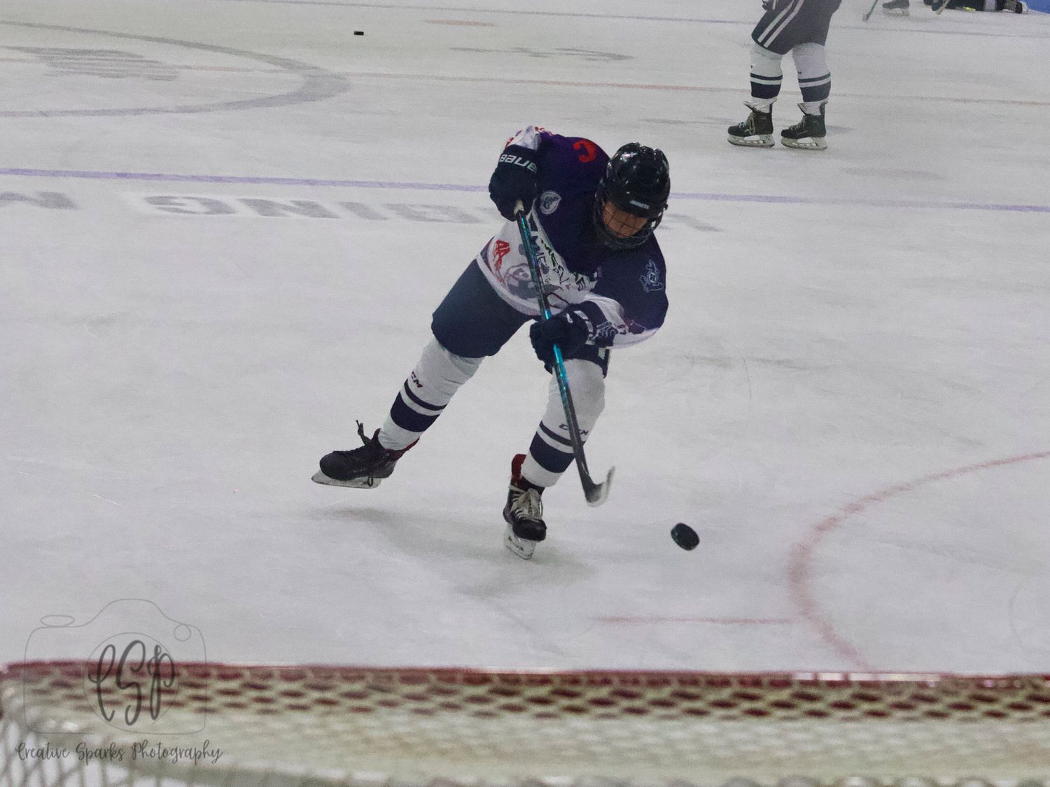 Northern MN hockey action shot capturing intensity, movement, and athletic performance