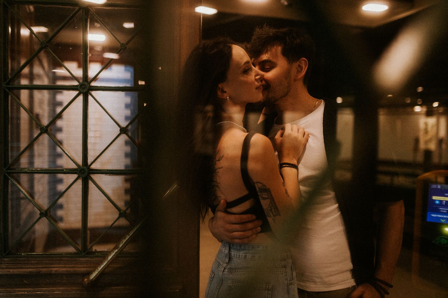 Candid portrait of young couple cuddling at the Opera metro station in Budapest