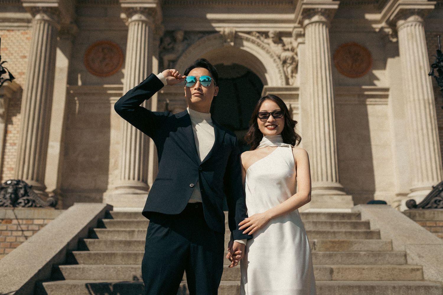 Asian couple posing for prewedding photos in front of Castle Garden Bazaar in Budapest