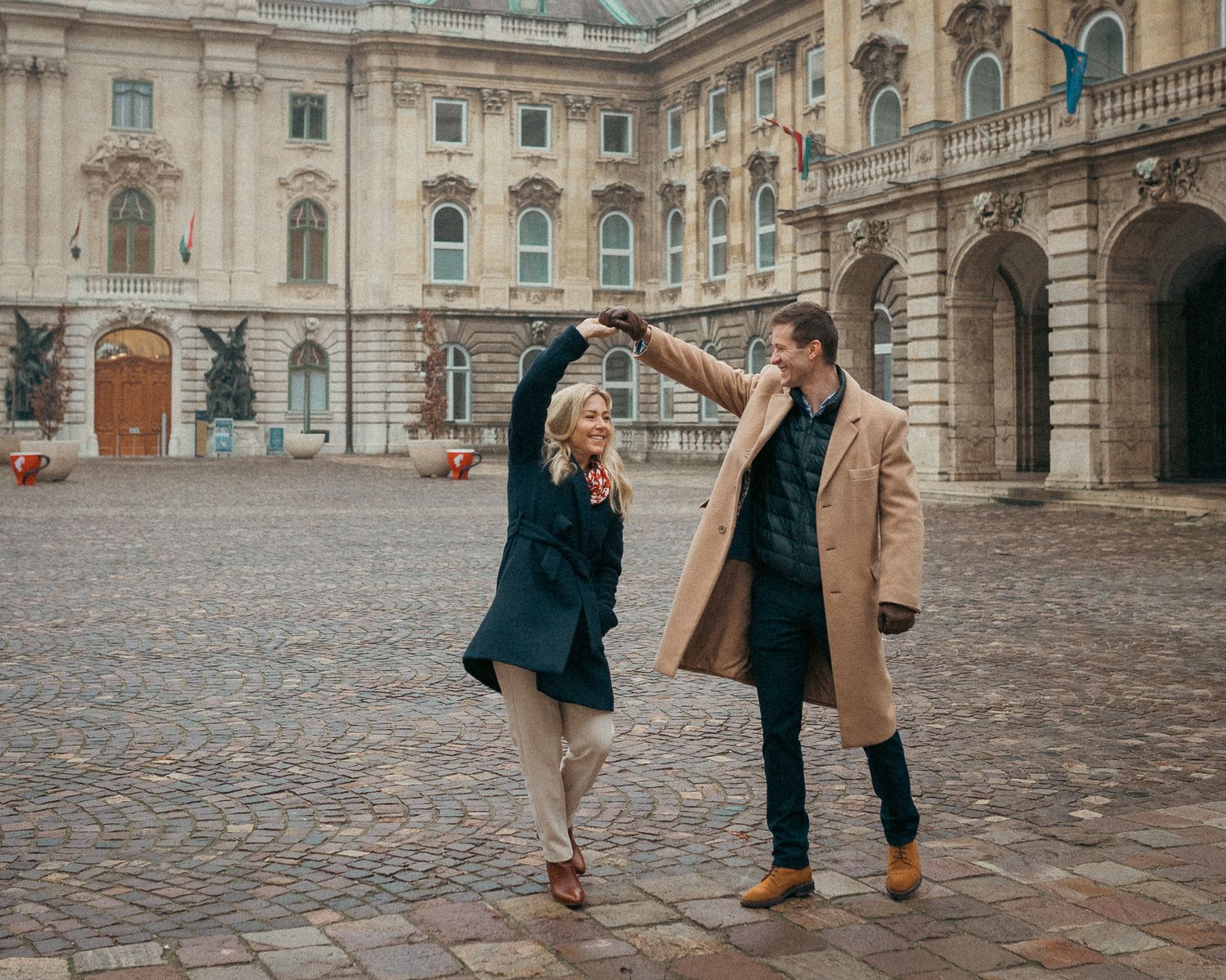 Elegant couple dancing as pose for their couple photos at Buda Castle