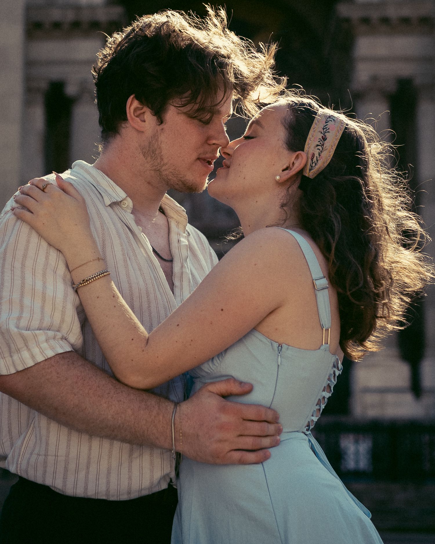 Candid portrait taken by Budapest photographer of lovebirds in the early morning sunlight