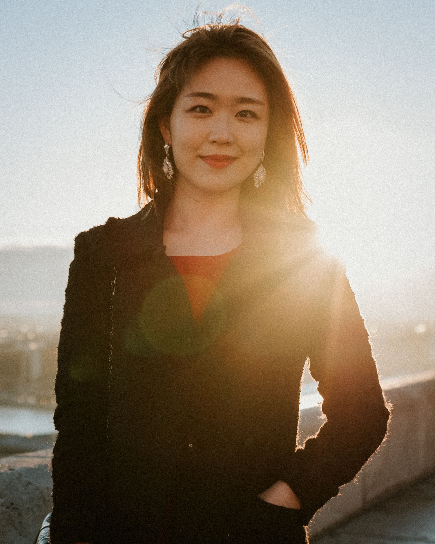 Young woman looking in the camera for her portrait in the sunrise