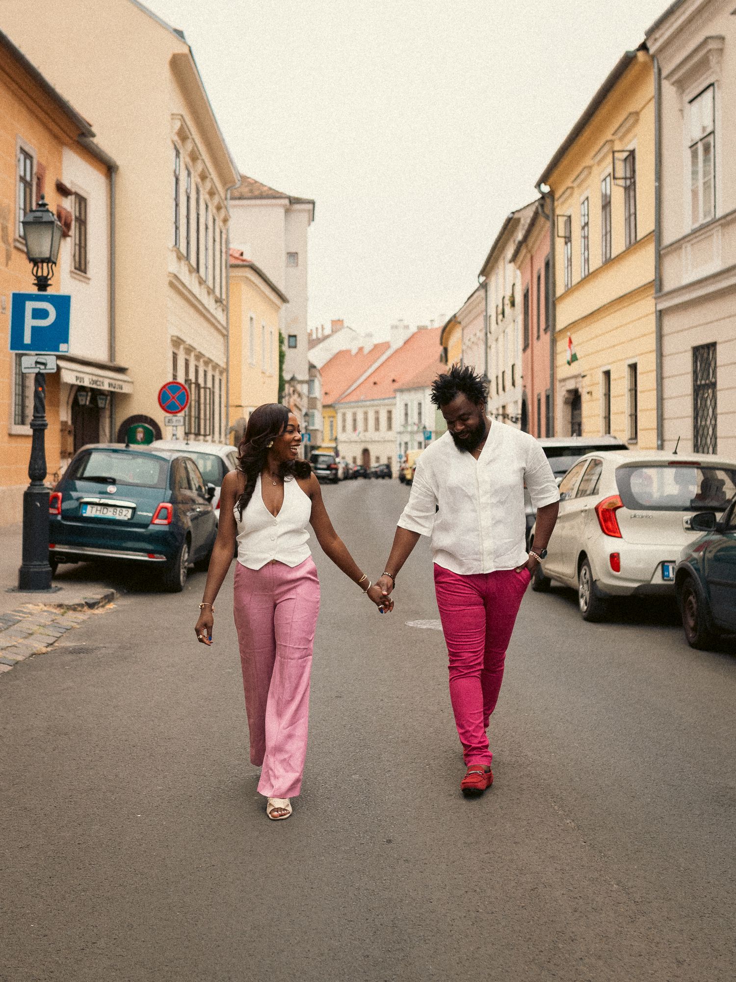 Stylish couple walking and talking in the medieval streets of the Buda Castle area