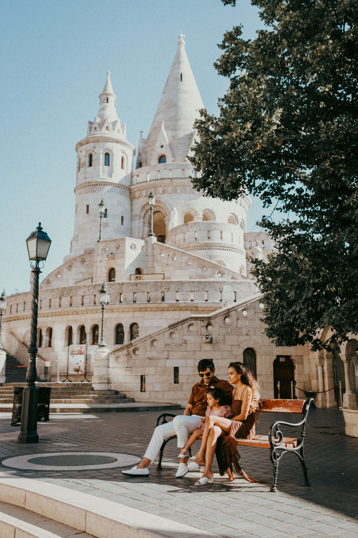 Family of three sitting on a bench