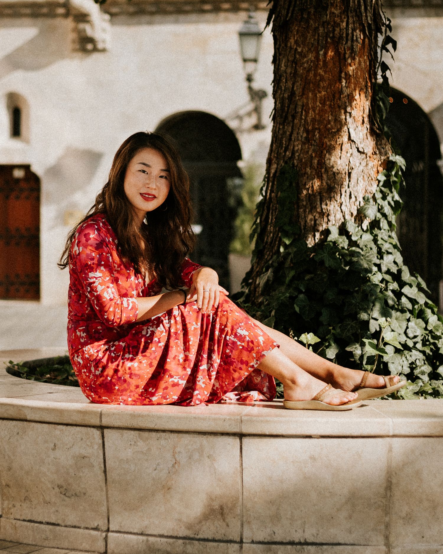Woman sitting on a bench in the shadow