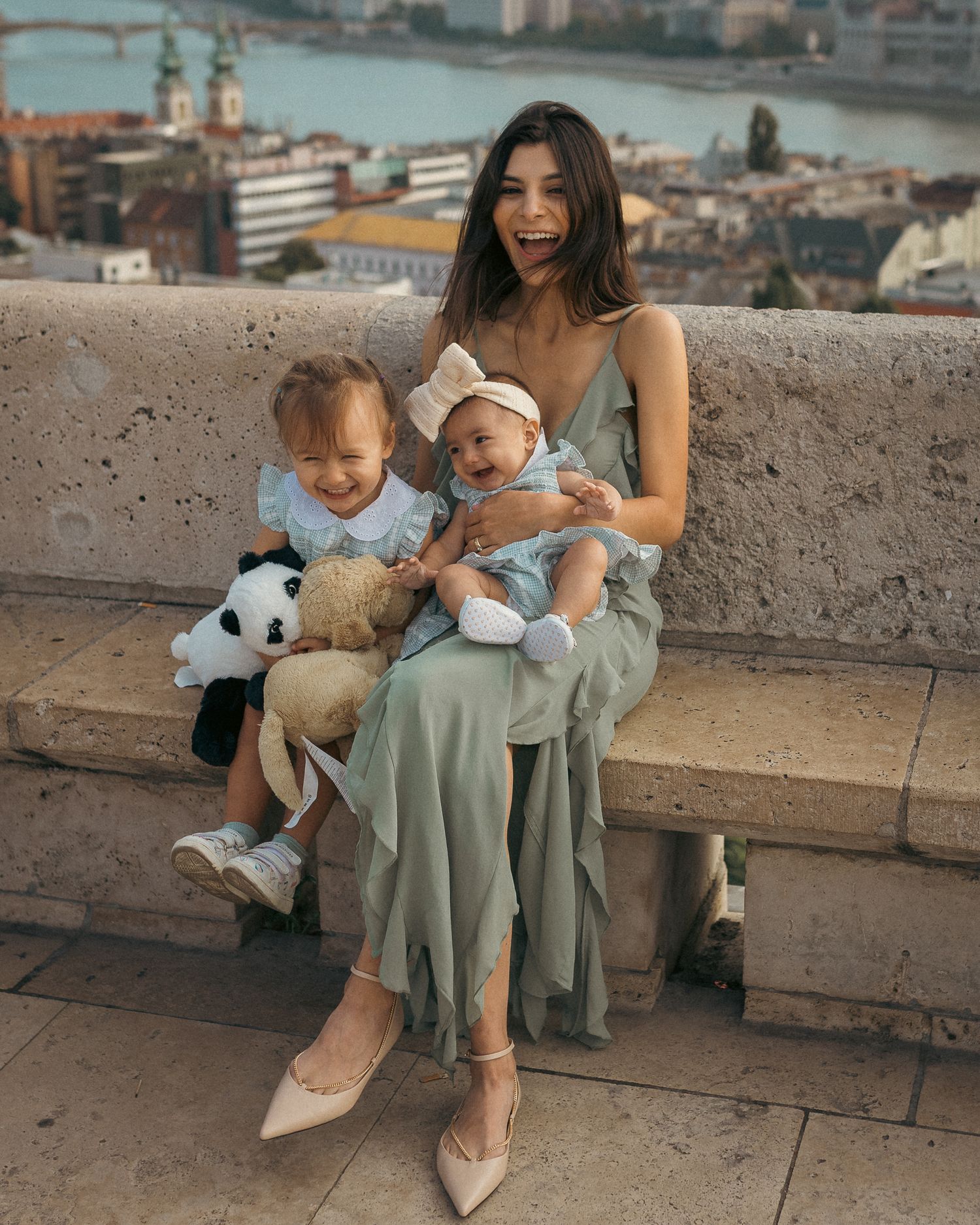 Young mother with her two little daughters playing and laughing during their Budapest family photo shoot with local photographer