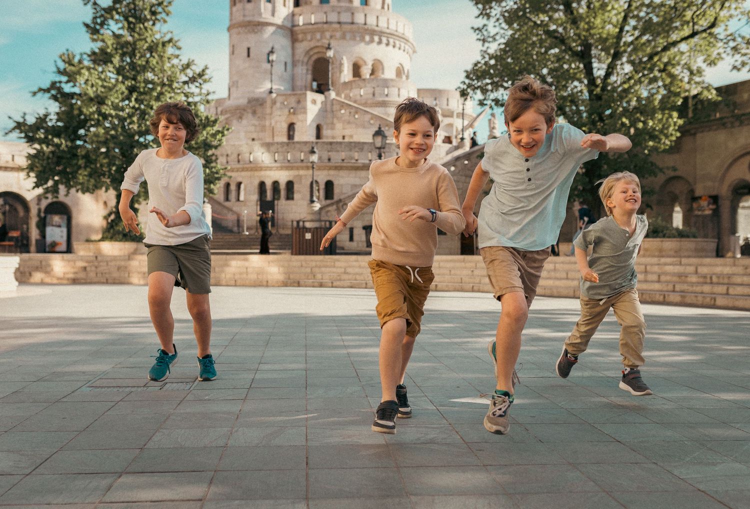 Kids running towards the photographer during a family photo session in Budapest.